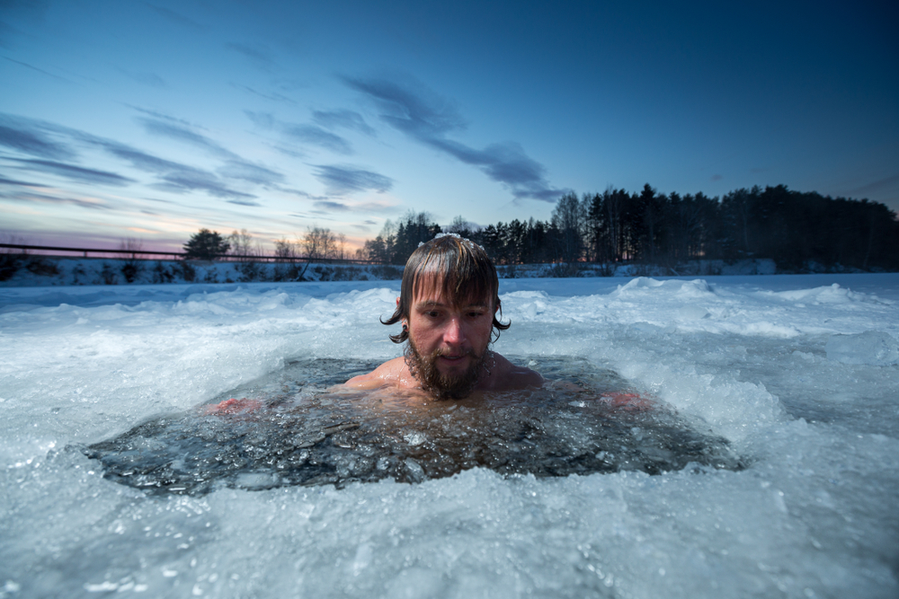 Young,Man,With,Beard,Swims,In,The,Winter,Lake