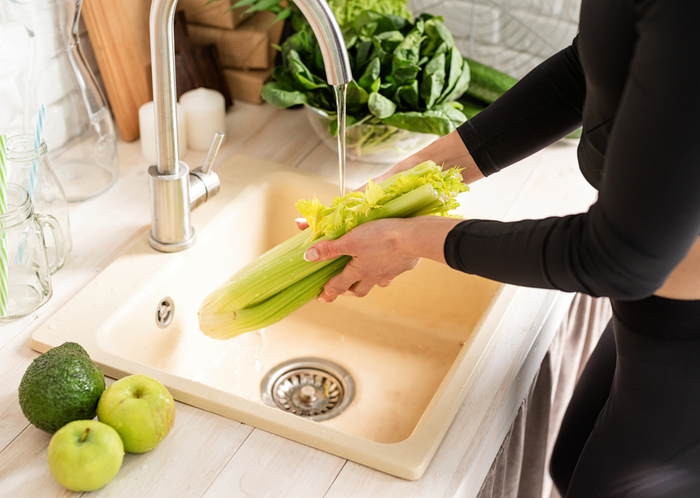 Woman,Washing,Celery,In,The,Kitchen,Sink