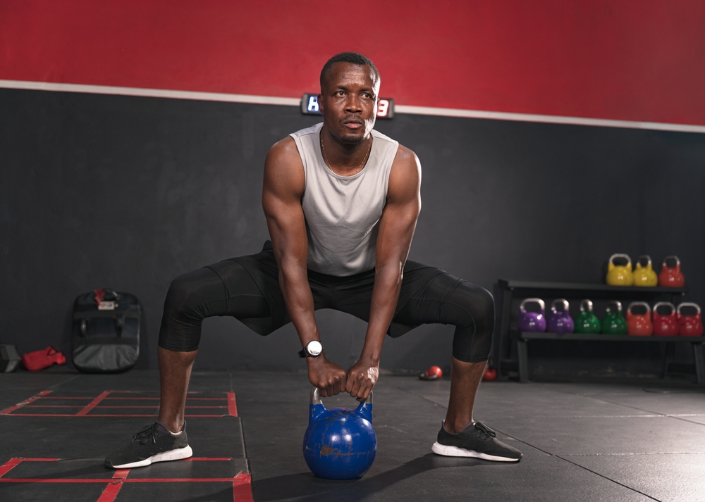 African,American,Sport,Man,Training,With,Kettlebell,In,Fitness,Gym