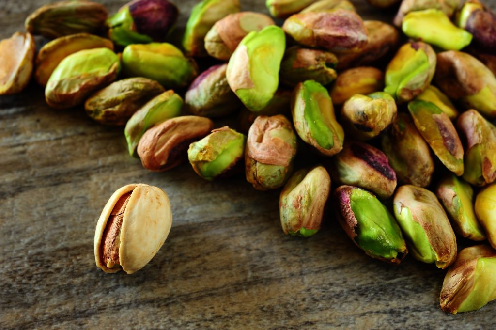 Close-up,Image,Of,Pistachios,On,Wooden,Background