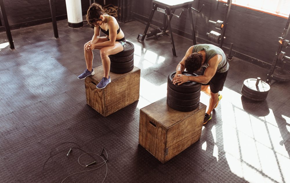Fitness,Man,And,Woman,Resting,On,Box,After,Exercises,In
