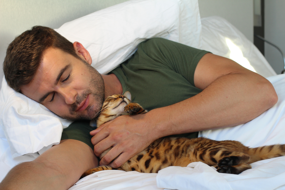 Man,Sleeping,With,His,Cat