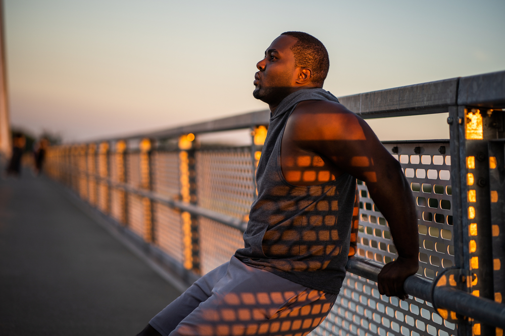 Young,African-american,Man,Is,Exercising,In,Sunset,On,The,Bridge