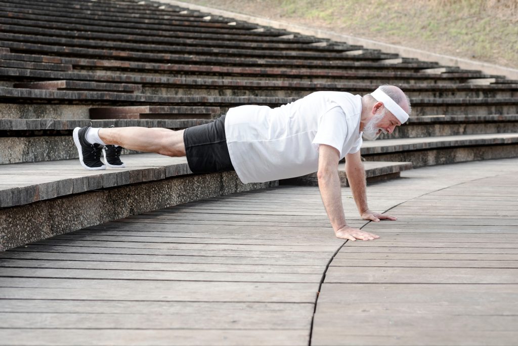 Elderly,Male,Retiree,Is,Doing,Push,Ups,Exercise,Outdoor.,Stay