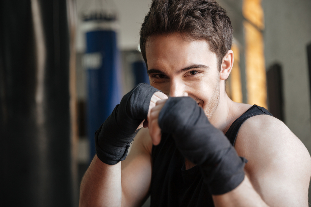 Close,Up,View,Of,Smiling,Boxer,Doing,Exercise,In,Gym