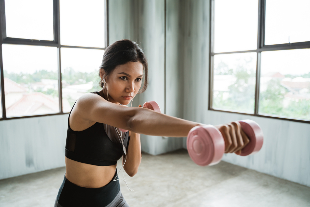Asian,Sport,Woman,Using,Dumbbell,Doing,Some,Boxing,Exercise,Indoor